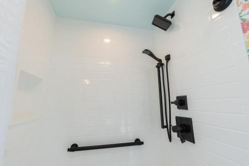 a shower with black fixtures on a white wall at Ocean House Boutique Hotel & Motel in Old Orchard Beach