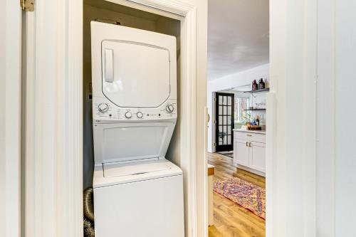 a white refrigerator freezer sitting inside of a kitchen at Deck, Fire Pit and Pool Access at Poconos Retreat! in East Stroudsburg