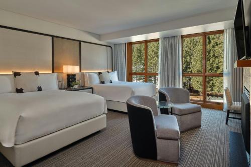 a hotel room with two beds and a couch at The Ritz-Carlton, Lake Tahoe in Truckee