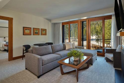 a living room with a couch and a table at The Ritz-Carlton, Lake Tahoe in Truckee