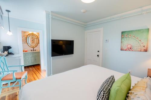 a bedroom with a bed and a flat screen tv at Ocean House Boutique Hotel & Motel in Old Orchard Beach