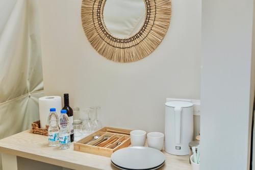 a bathroom counter with a mirror and a toilet at Geometry Park in Ayios Theodhoros