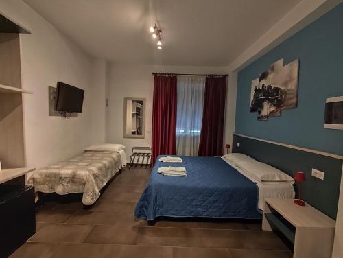a hotel room with two beds and a tv at Belvedere Rooms Guest House in Rome