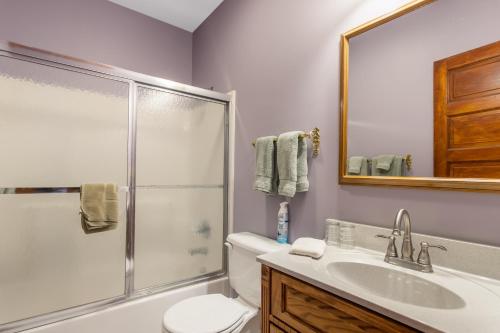 a bathroom with a shower and a toilet and a sink at Inn of Saugatuck in Saugatuck