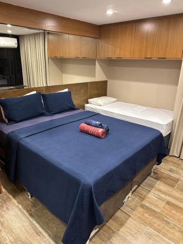 a bedroom with two beds on a boat at Flat no Life Resort a Beira Lago in Brasilia