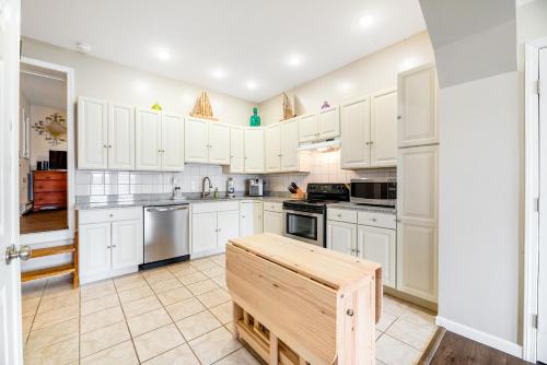 a kitchen with white cabinets and a table in it at Live Laugh Lake - A in Rushville