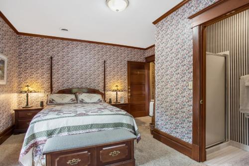 a bedroom with a bed and a large mirror at Inn of Saugatuck in Saugatuck
