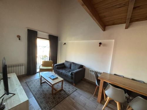 a living room with a couch and a table at NB Mountain aparts El Chalten in El Chalten
