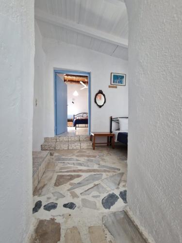 a hallway with a room with a bed and a door at Iliana's Bungalow in Arménoi