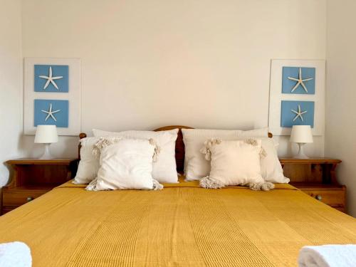 a bedroom with a large bed with white pillows at Casa vacanza tra il mare e il centro di San Teodoro in San Teodoro