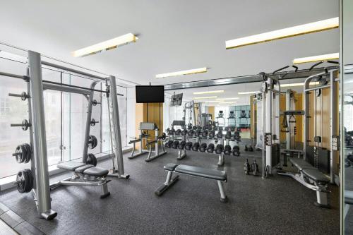 a gym with several treadmills and weights at Le Meridien Taipei in Taipei