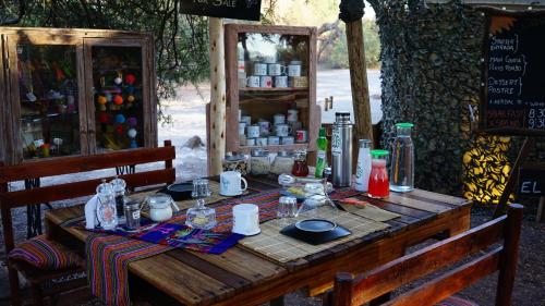 a wooden table with food on top of it at El Huarango Eco Lodge in La Huaica