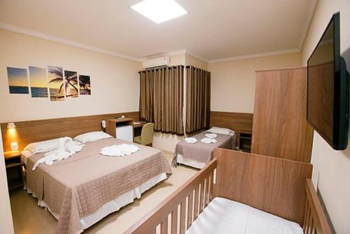 Postel nebo postele na pokoji v ubytování Vitoria Palace Hotel