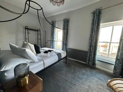 a bedroom with a bed and a chandelier at The Round House in Strangford