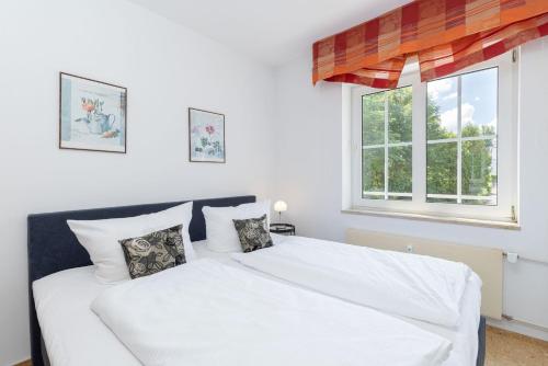 En eller flere senge i et værelse på Seepark Wohnung 23