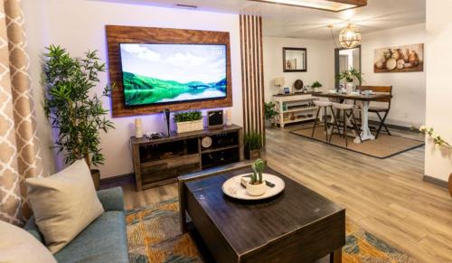a living room with a large television on the wall at Upscale Ybor House with Outdoor Living Space in Tampa