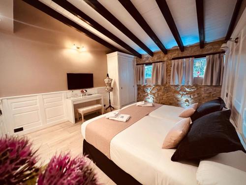 a bedroom with a large bed and a desk at La Quinta Luxury Palace in Arnuero