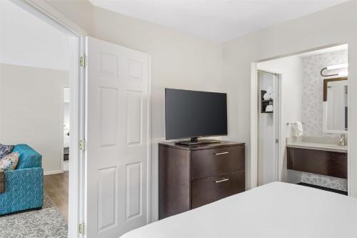 a bedroom with a bed and a tv on a dresser at Sonesta ES Suites Chatsworth in Chatsworth