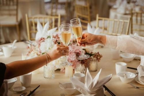 a group of people holding champagne glasses at a table at AC Hotel by Marriott Ipoh in Ipoh