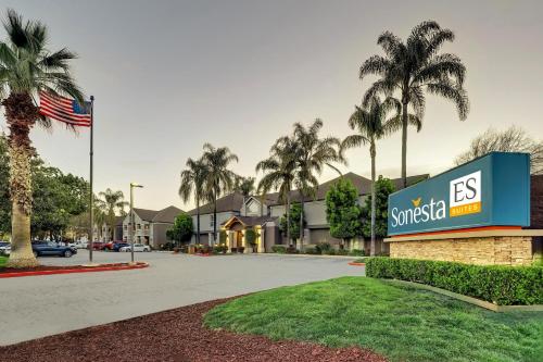 a view of a resort with palm trees and a building at Sonesta ES Suites San Jose - Airport in San Jose