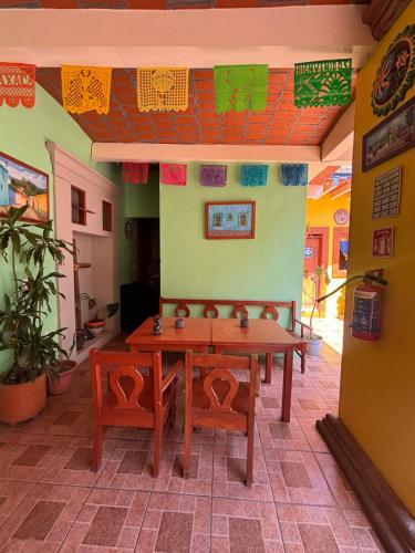 a dining room with a table and two chairs at Hotel Posada "Mi Rosita" in Oaxaca City