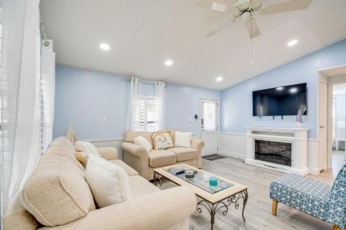 a living room with a couch and a fireplace at Golf and Pool Access Home with Yard in Lady Lake in Lady Lake