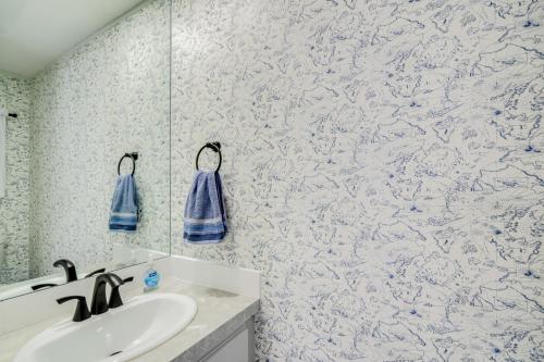 a bathroom with a sink and a blue and white wallpaper at Golf and Pool Access Home with Yard in Lady Lake in Lady Lake