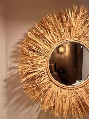 a wreath on a wall with a mirror on it at Theros in Karistos