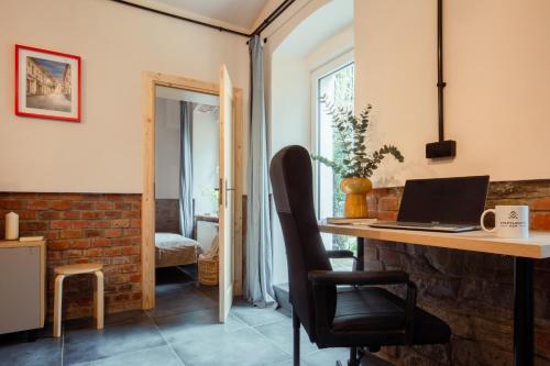 a room with a desk with a laptop on it at Apartamenty KDN Garden in Bielsko-Biała