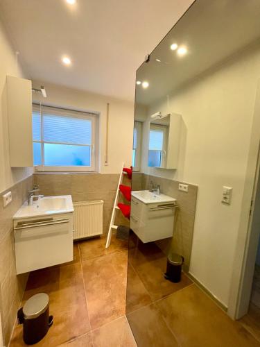 a bathroom with a sink and a mirror at Ferienwohnung Schwarzwaldnest im Heimbachtal in Loßburg