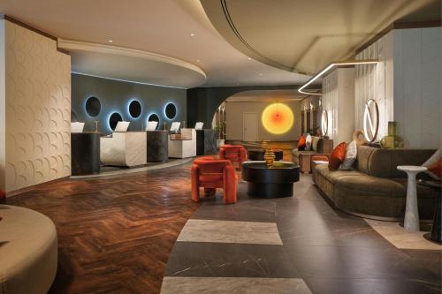 a living room with a couch and chairs and a lobby at Cardo Roma, Autograph Collection in Rome