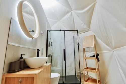 a bathroom with a glass shower and a sink at Geometry Park in Ayios Theodhoros