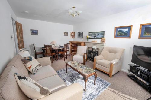 a living room with a couch and a tv at Beautiful attractive house free parking near Airport in Edinburgh