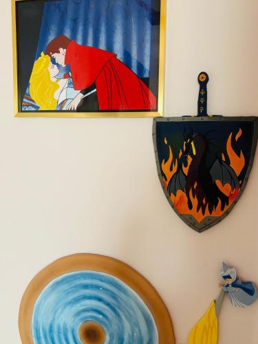 a picture of a superhero on a wall with a shield at THE ENCHANTED HOUSE ( 15 min walk to Disney) in Serris