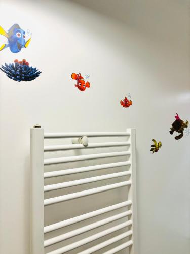 a room with three fish stickers on the wall at THE ENCHANTED HOUSE ( 15 min walk to Disney) in Serris