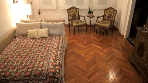 a living room with a couch and chairs and a table at Garden room with terrace in Genova