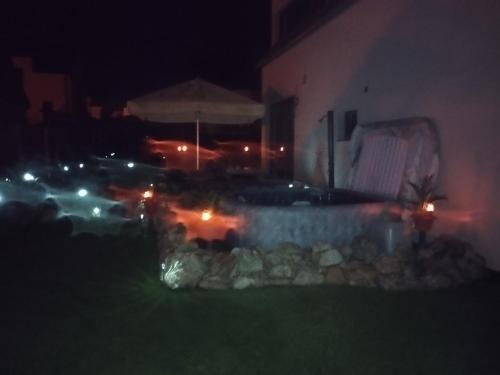 a backyard at night with lights in the grass at Apartmán Dáša in Frymburk
