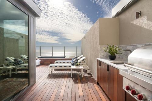 a balcony with a view of the ocean at The Ritz-Carlton Residences, Waikiki Beach Hotel in Honolulu