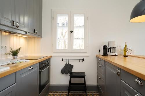 a kitchen with gray cabinets and a counter top at Weißes Haus 9123II in Fehmarn