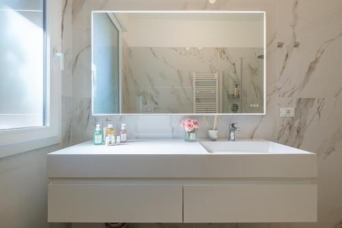 a bathroom with a white sink and a mirror at Sant'Orsola Lodge Bologna in Bologna