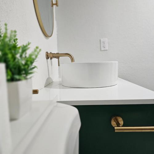 a bathroom with a sink and a potted plant at Simple Serenity in Freeport