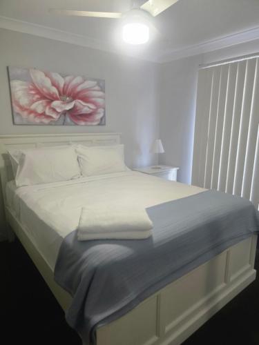 a bedroom with a bed with a flower painting on the wall at Bayview Anchorage in Gold Coast