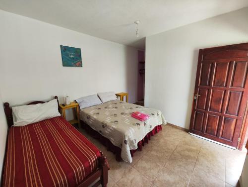 a bedroom with a bed and a door to a room at Hostería Melodías de la Naturaleza in Yala