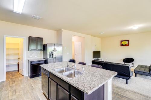 a kitchen with a sink and a living room at Less Than 20 Mi to Dtwn Austin Home in Quiet Neighborhood in Manor