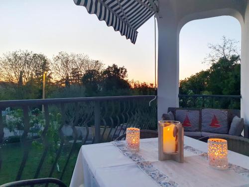 a table with a candle on top of a porch at Diana apartment in Gabonjin