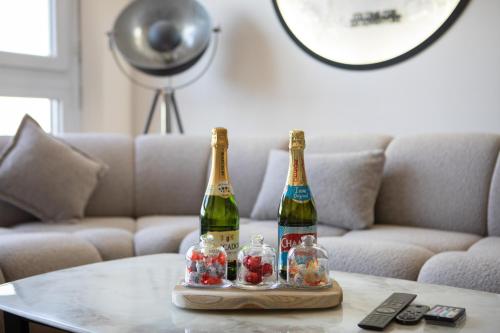 two bottles of champagne on a table in front of a couch at CosmoDream in Mulhouse