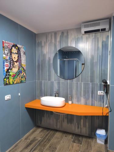 a bathroom with a sink and a mirror at Appia Apartment - Camera Fiorellino in Santa Maria a Vico