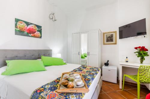 a bedroom with a bed with a tray of food on it at Villa Giummarito in Scicli