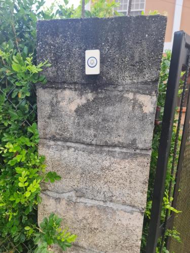 a stone wall with a button on it at GM Suites Bed & Breakfast in Belmopan
