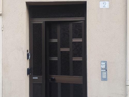 a black door with a sign in front of it at New private apt in Como whit A-C Comfort - Elegant - Comfortable in Como